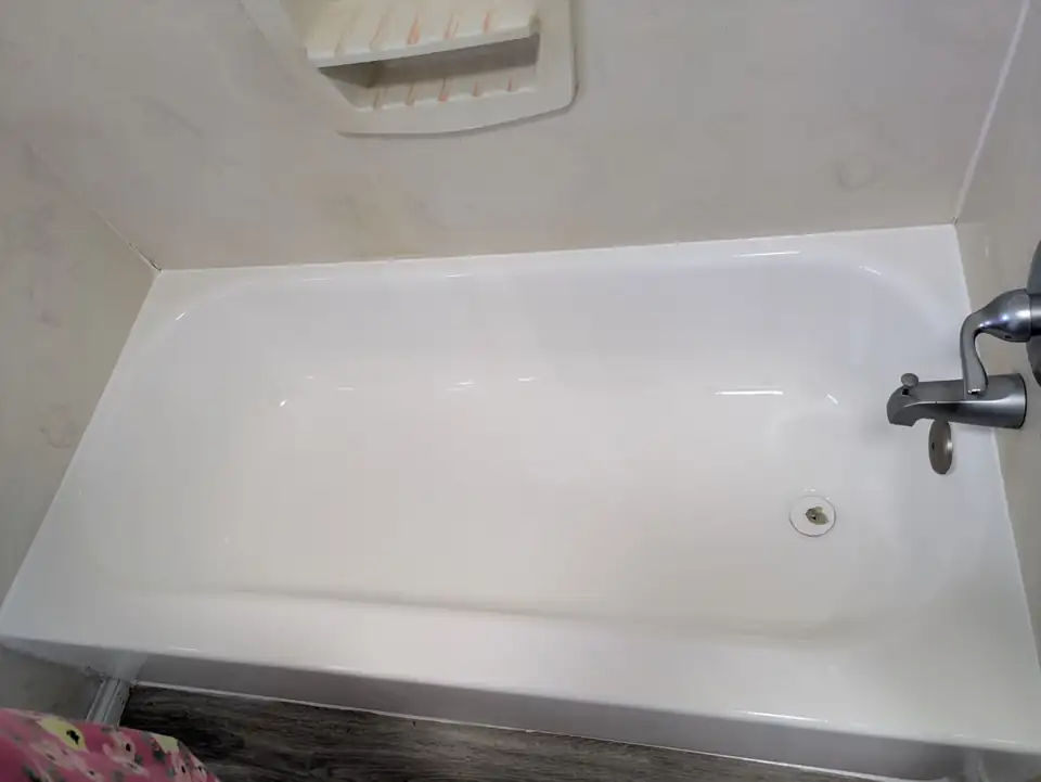 Tub refinishing in Woodway, TX by B&J Refinishing: an old rusted bathtub resurfaced to a glossy white finish